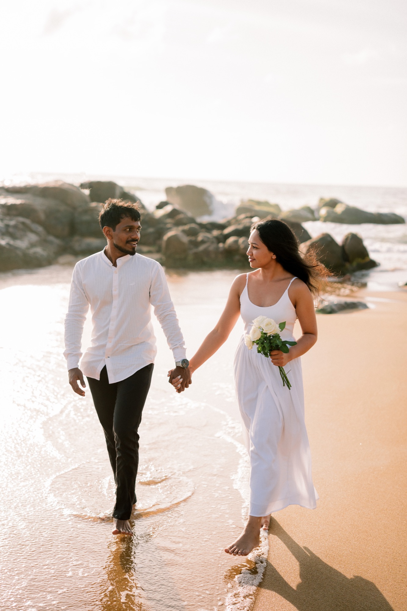 Wazeefa and Damiru walking hand in hand along the shore