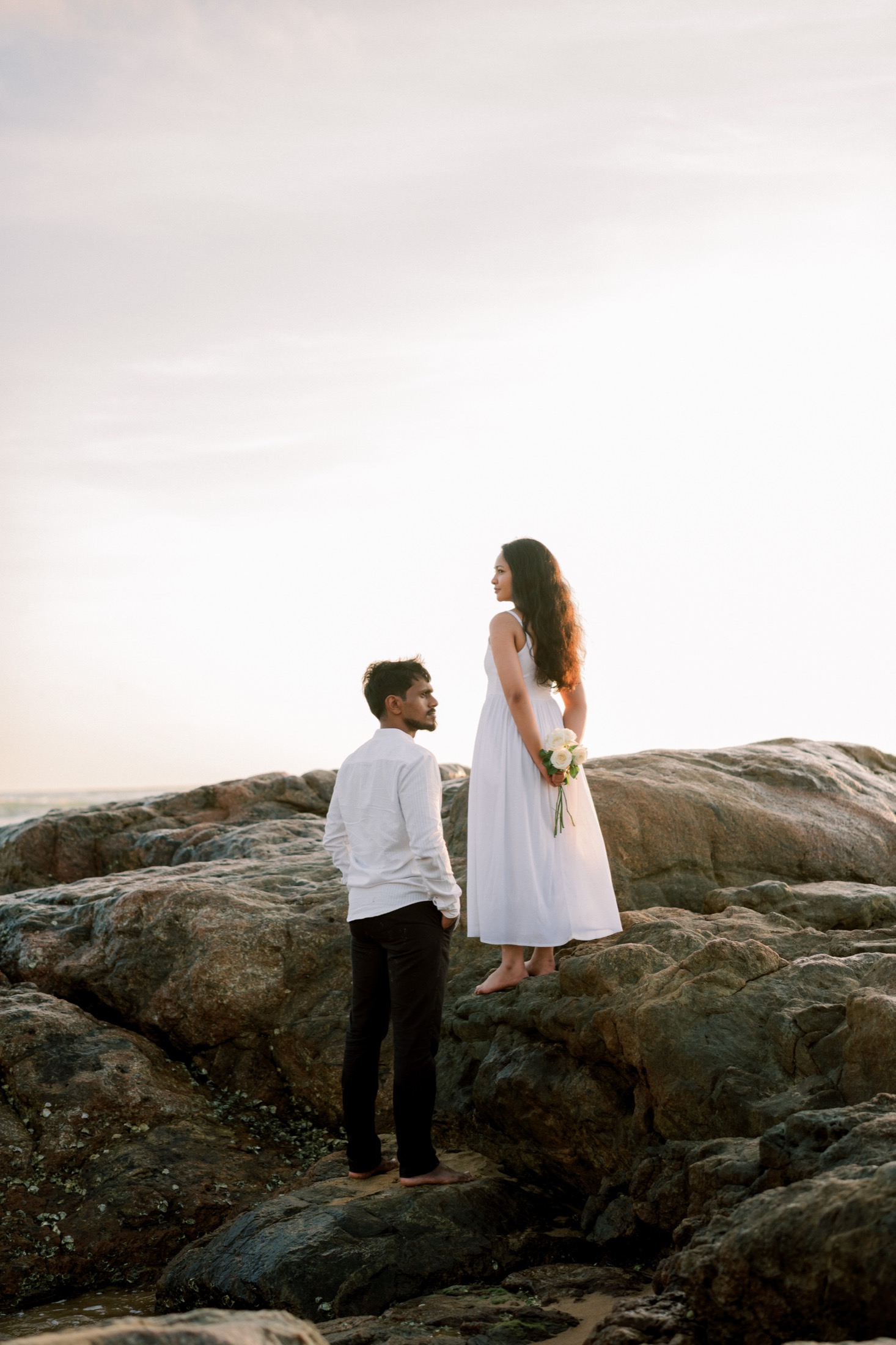 Wazeefa and Damiru standing together on the rocks under an open sky